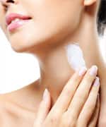 Woman apply cream on neck