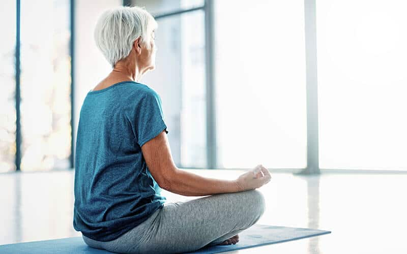 Mature woman meditating