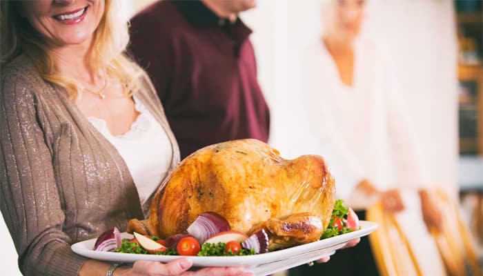 Woman holding a holiday turkey which may be a healthier food choice