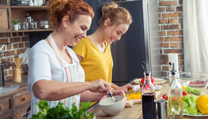 mother and daughter cooking healthy meal