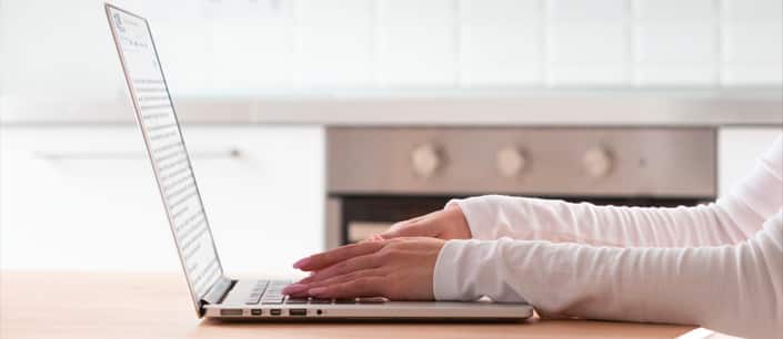 Hands typing on computer
