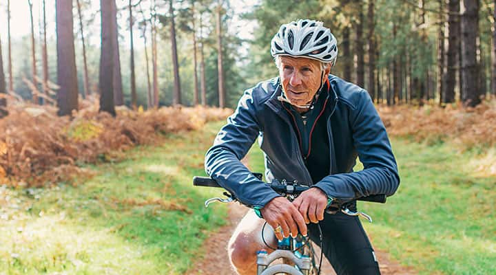 Elderly man riding a bike