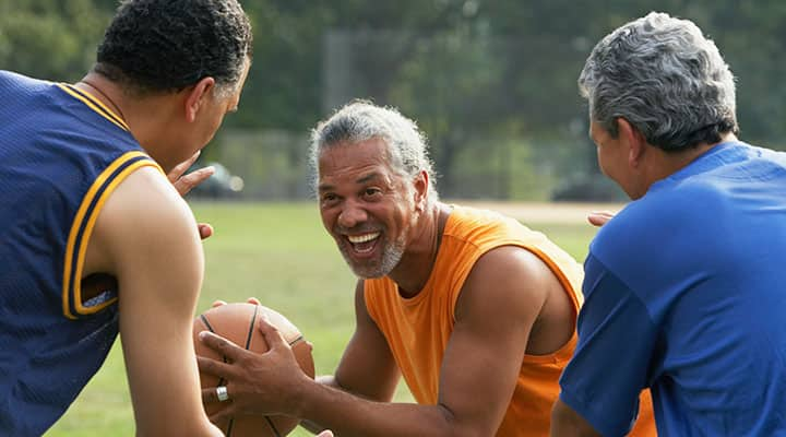 Active senior men playing basketball