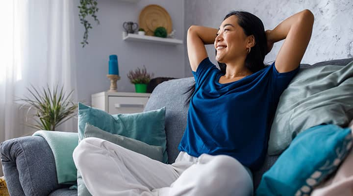 Calm woman relaxing on sofa