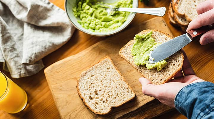 Preparing avocado toast for breakfast