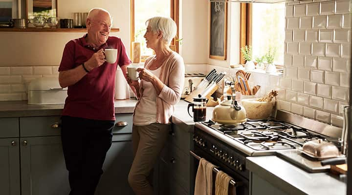 Man and woman drinking coffee in the kitchen