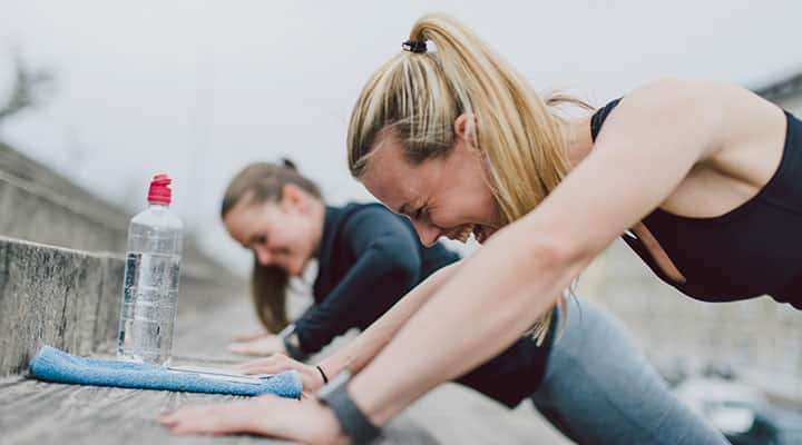 Two women exercise to help maintain weight loss