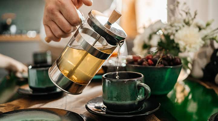 Pouring herbal tea from a French press