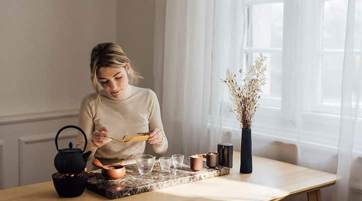 Woman making a cup of herbal tea