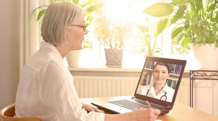 Older woman having a virtual appointment with her dermatologist>