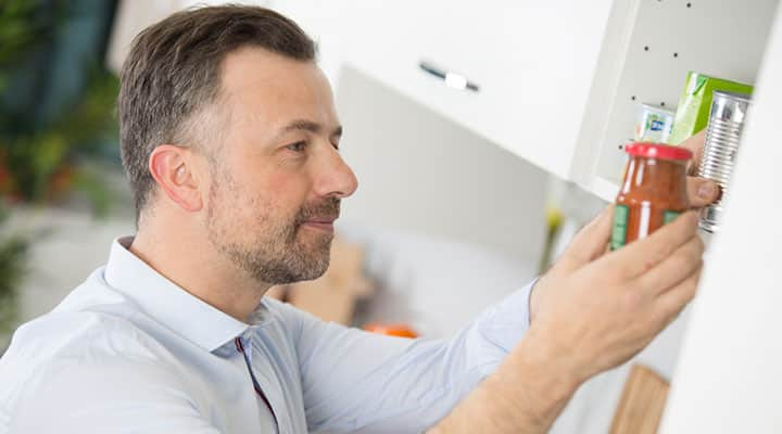 Man inspecting a pantry for gluten