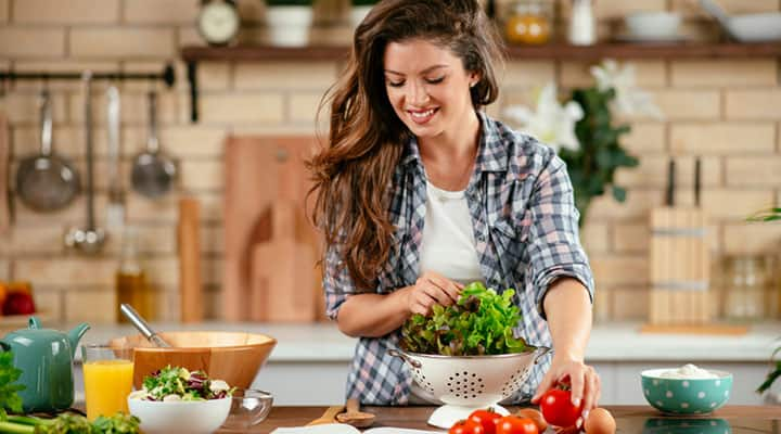 Woman preparing healthy gluten-free meals on kitchen counter