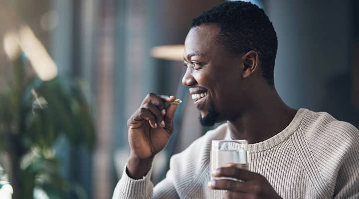 Man taking a supplement to support immune health