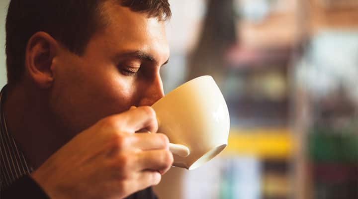 Man drinking chamomile tea for better sleep