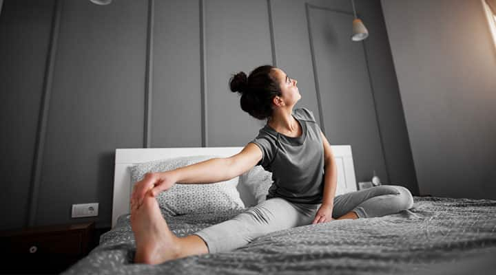 Woman stretching in bed