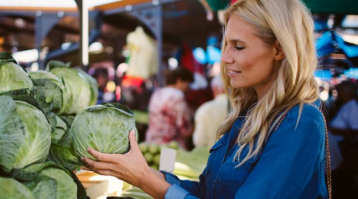 Woman shopping for cabbage