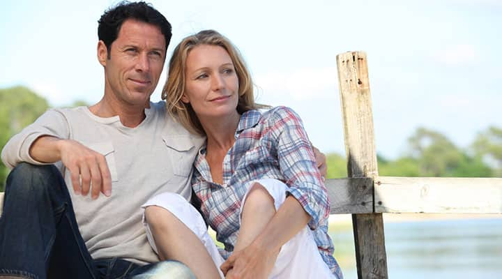 A couple relaxing on dock after a meal full of healthy garlic