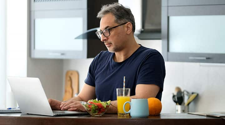 Man on healthy garlic diet using a loptop computer