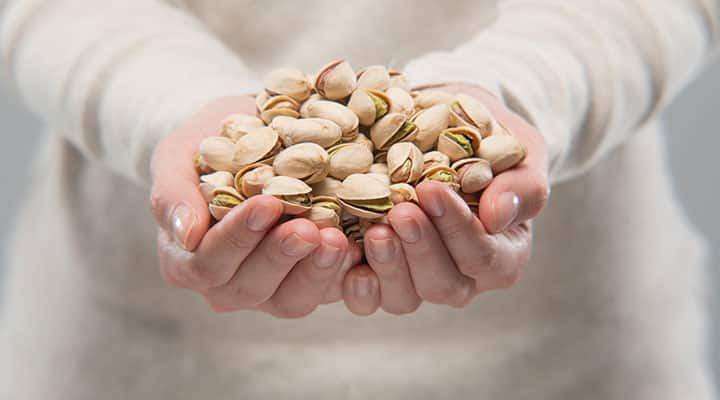 Handful of pistachios which are high in fiber and protein