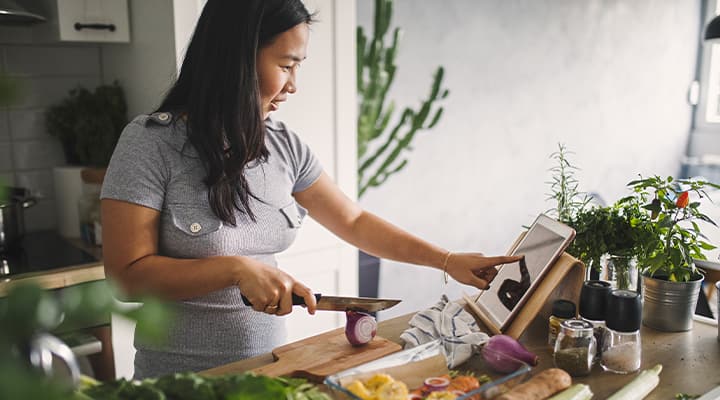 Woman cooking ALA rich vegetables in the kitchen