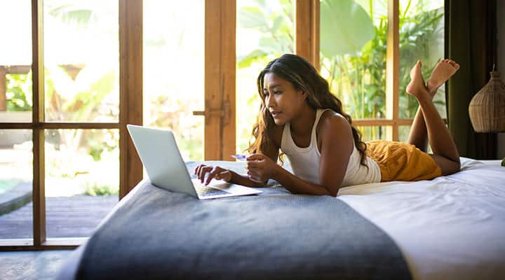 Woman reading about milk thistle on laptop