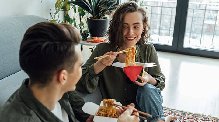 Man and woman eating junk food