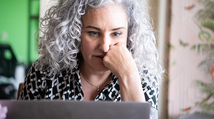 Older woman spending time in front of computer screen that benefit from eye supplements