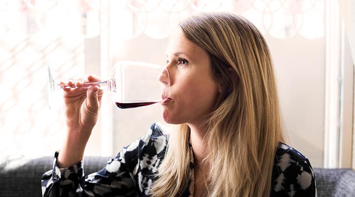 Woman drinking wine, but not enough get a hangover