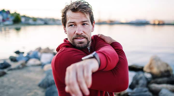 Man stretching while exercising outdoors