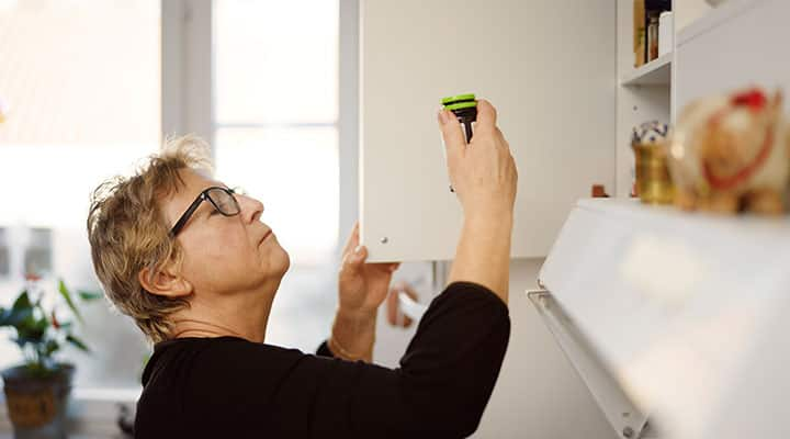 Woman putting away supplements in a cool dark place