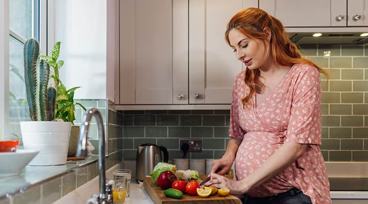 Pregnant woman eating vitamin-rich foods