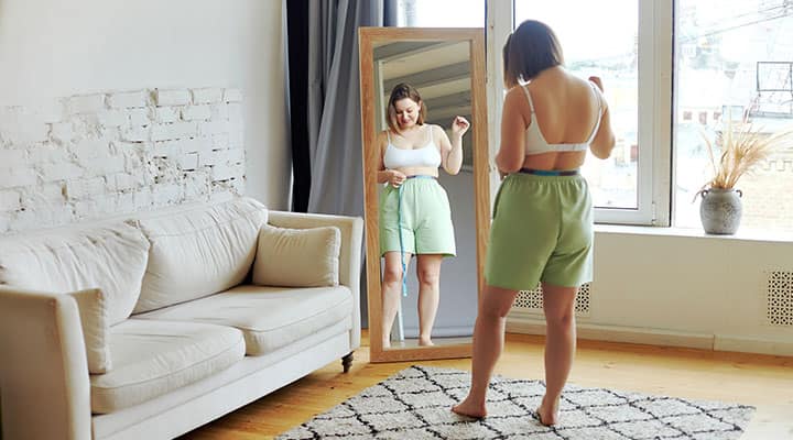 Woman measuring her waist