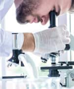 Doctor looking into microscope