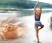 Woman doing yoga in front of lake