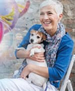 Woman holding dog who’s boosting immune system