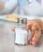 Man reaching for salt shaker