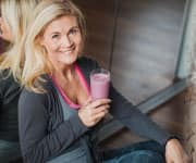 Woman having smoothie for post workout