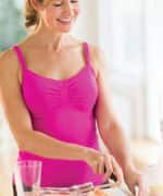 Woman in pink shirt preparing a salad