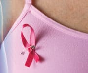 Woman wearing pink ribbon pin