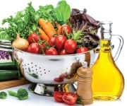 Large metal colander filled with brightly colored vegetables