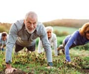 Group of older people exercising outside
