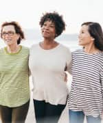 3 woman walking on the beach