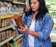 Woman in grocery store reading label