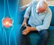 Man holding knee in pain due to joint deterioration