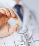 Doctor holding fish oil with heart rate below