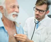 Man having heart listened to by physician