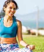 Woman sitting in park doing yoga