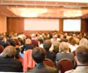 People sitting in conference listening to health presentation