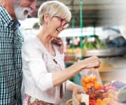 Couple grocery shopping for fruits and vegetables for phytonutrients