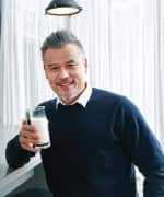 Man drinking milk that is formulated to support bone, muscle, and joint health